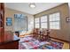 Sunlit office features hardwood floors, multiple windows, and comfortable seating for work or relaxation at 2411 S Milwaukee St, Denver, CO 80210