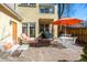 The patio features a lounge chair and table, and is shaded by a large orange umbrella at 2411 S Milwaukee St, Denver, CO 80210