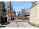 A view of the street showing surrounding houses and utility poles on a sunny day at 2411 S Milwaukee St, Denver, CO 80210