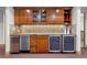 Features granite countertops, tile backsplash, wood cabinetry and two beverage refrigerators at 2411 S Milwaukee St, Denver, CO 80210