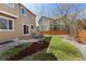 Backyard with lawn, patio, and plantings perfect for outdoor entertaining and relaxation at 512 Cardens Pl, Erie, CO 80516
