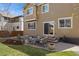 Backyard with patio, seating, garden area, and well-maintained lawn space at 512 Cardens Pl, Erie, CO 80516