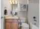 Cozy bathroom featuring a vanity, toilet, shower/tub combination, and decorative storage at 512 Cardens Pl, Erie, CO 80516