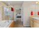 Bathroom featuring a glass shower and tub at 512 Cardens Pl, Erie, CO 80516