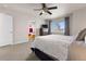 A spacious bedroom with a large window and TV at 512 Cardens Pl, Erie, CO 80516
