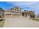 Inviting home with a three car garage, brick accents and covered front porch at 512 Cardens Pl, Erie, CO 80516