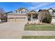 Charming home with a three car garage, brick accents, and well-manicured lawn at 512 Cardens Pl, Erie, CO 80516