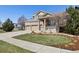Inviting home exterior with lush lawn, landscaping, and two car garage at 512 Cardens Pl, Erie, CO 80516