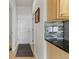 Hallway featuring tiled backsplash, lighting, and doorway views to other rooms at 512 Cardens Pl, Erie, CO 80516