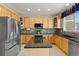 Modern kitchen with stainless steel appliances, island, and ample cabinet space at 512 Cardens Pl, Erie, CO 80516