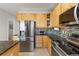 Modern kitchen features stainless steel appliances, granite counters, and stylish backsplash at 512 Cardens Pl, Erie, CO 80516