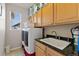 Functional laundry room with wood cabinets, granite countertop, and washer/dryer at 512 Cardens Pl, Erie, CO 80516