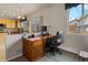 Bright home office featuring a wooden desk, chair, and outside view at 512 Cardens Pl, Erie, CO 80516