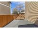 Side yard featuring a wood fence, small wood gate, and gravel/concrete patio at 512 Cardens Pl, Erie, CO 80516