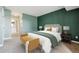 Relaxing bedroom featuring accent wall, carpeted floor, and connecting bathroom at 12338 W Dorado Pl # 206, Littleton, CO 80127