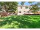 Exterior of home with a backyard featuring a large, lush green lawn area at 19428 E Crestridge Cir, Centennial, CO 80015