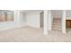 Spacious, carpeted basement features a window, a shelving unit, and stairway access at 19428 E Crestridge Cir, Centennial, CO 80015