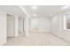 Finished basement with neutral carpet, white walls, and support beams offers versatile living space at 19428 E Crestridge Cir, Centennial, CO 80015