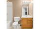 This bathroom has a shower-tub combination, toilet, and single sink vanity with a light wood cabinet at 19428 E Crestridge Cir, Centennial, CO 80015