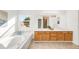 Bright bathroom with a large tub, a dual sink vanity, and a large mirror at 19428 E Crestridge Cir, Centennial, CO 80015