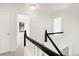 Bright hallway with white trim, neutral carpet, and natural light streaming through window at 19428 E Crestridge Cir, Centennial, CO 80015