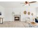Inviting living room with a stone fireplace, ceiling fan, neutral chair, and decor at 19428 E Crestridge Cir, Centennial, CO 80015