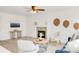 Open-concept living room featuring a stone fireplace, modern decor, and plenty of natural light at 19428 E Crestridge Cir, Centennial, CO 80015