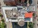 Aerial view showcasing the building's rooftop deck with seating, a dining area, and water tower at 1628 14Th St # 6A, Denver, CO 80202