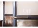 Close up of a detailed leather wrapped door handle with modern bronze metal hardware at 1628 14Th St # 6A, Denver, CO 80202