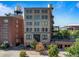 Brick building exterior featuring architectural details, trees, and the rooftop deck in the background at 1628 14Th St # 6A, Denver, CO 80202