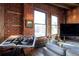 Cozy living room with exposed brick and expansive windows offering city views at 1628 14Th St # 6A, Denver, CO 80202