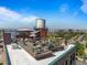 Rooftop view with comfortable seating, a shade sail, a water tower, and views of the city and mountains at 1628 14Th St # 6A, Denver, CO 80202