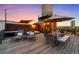 Inviting rooftop deck featuring lounge chairs, dining area, and a water tower with city views at sunset at 1628 14Th St # 6A, Denver, CO 80202