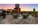 Relaxing rooftop deck showcasing comfortable seating, potted plants, and scenic city views at sunset at 1628 14Th St # 6A, Denver, CO 80202