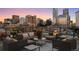 Relaxing rooftop deck with comfortable seating offers beautiful city views at sunset at 1628 14Th St # 6A, Denver, CO 80202