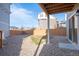 Picturesque backyard featuring gravel landscaping, small grass area, and new wooden fence at 16347 E 111Th Dr, Commerce City, CO 80022