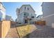 An open backyard with a small grass area, gravel landscaping, and a two-story home at 16347 E 111Th Dr, Commerce City, CO 80022