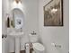 Half bathroom featuring pedestal sink, oval mirror, and neutral paint at 16347 E 111Th Dr, Commerce City, CO 80022