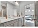 Bathroom featuring double sink vanity with gray cabinets and quartz countertop at 16347 E 111Th Dr, Commerce City, CO 80022