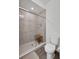 Bathroom featuring glass enclosed shower with bench and handheld shower head at 16347 E 111Th Dr, Commerce City, CO 80022