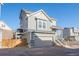 Charming three-story house with a two-car garage, stone accents, and a small balcony at 16347 E 111Th Dr, Commerce City, CO 80022