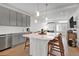 Well-appointed kitchen featuring gray cabinets, stainless steel appliances, and a large center island at 16347 E 111Th Dr, Commerce City, CO 80022