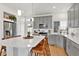 Modern kitchen with a large island, white countertops, stainless steel appliances, and gray cabinets at 16347 E 111Th Dr, Commerce City, CO 80022