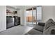 A laundry room with modern washer and dryer, shelf storage, and sliding glass door to the backyard at 16347 E 111Th Dr, Commerce City, CO 80022