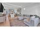 Open-concept living room seamlessly connects to the kitchen with modern gray color palette at 16347 E 111Th Dr, Commerce City, CO 80022