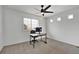 Home office featuring natural light, neutral paint and carpet, and black desk at 16347 E 111Th Dr, Commerce City, CO 80022