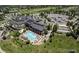 Aerial view shows community clubhouse with pool, tennis courts, and parking at 23590 E Jamison Pl, Aurora, CO 80016