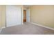 Neutral bedroom with sliding closet doors and an open doorway to the hallway at 23590 E Jamison Pl, Aurora, CO 80016