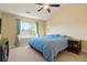 Vaulted ceiling primary bedroom with a large window, neutral walls and carpeted floor at 23590 E Jamison Pl, Aurora, CO 80016