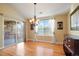 Inviting dining area with hardwood floors, modern chandelier and natural lighting at 23590 E Jamison Pl, Aurora, CO 80016